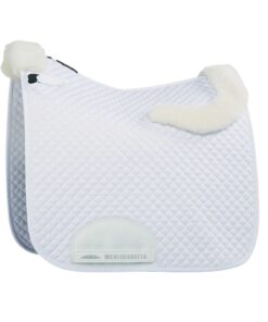 The WeatherBeeta Dressage Saddle Pad has a soft and durable polycotton outer with added premium thick rolled sheep wool to look like a built in half pad The PVC-covered girth patch provides added durability